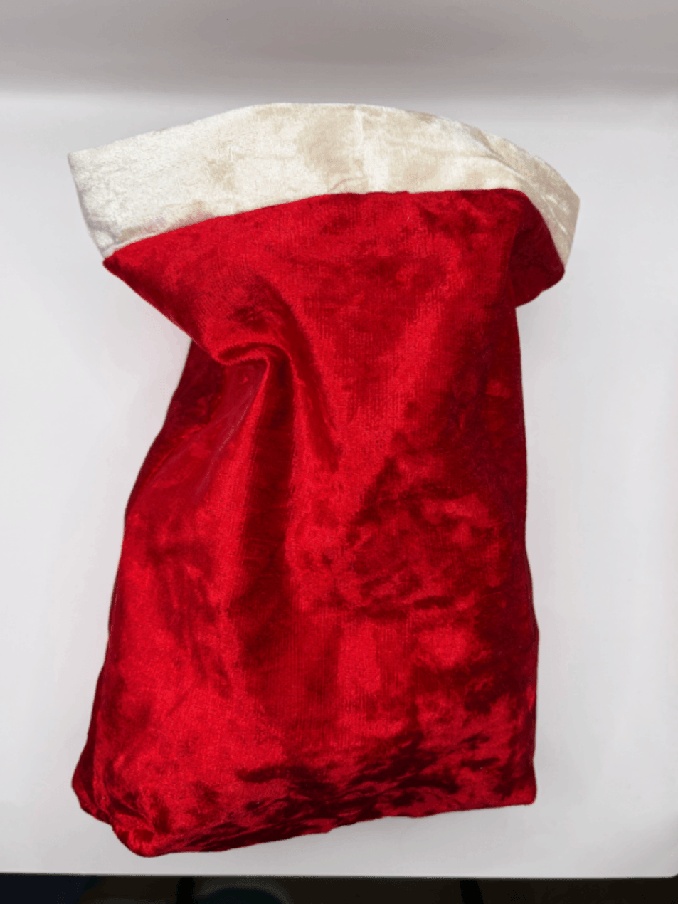 Back view of a plain red velvet Fur Baby Santa Sack with white trim