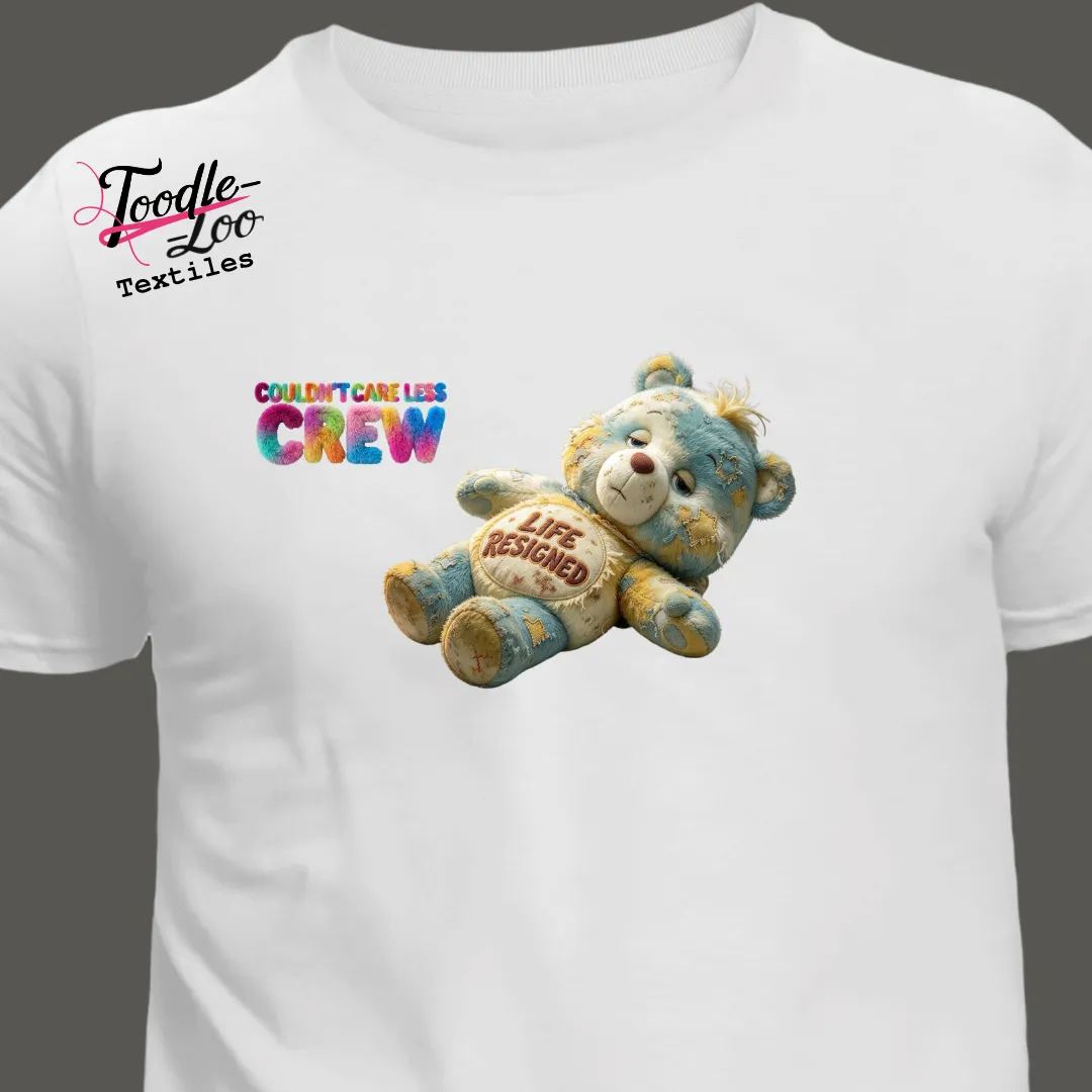 Life Resigned bear design on a white tee — Couldn’t Care Less Crew DTF print, shown as an AI mock-up