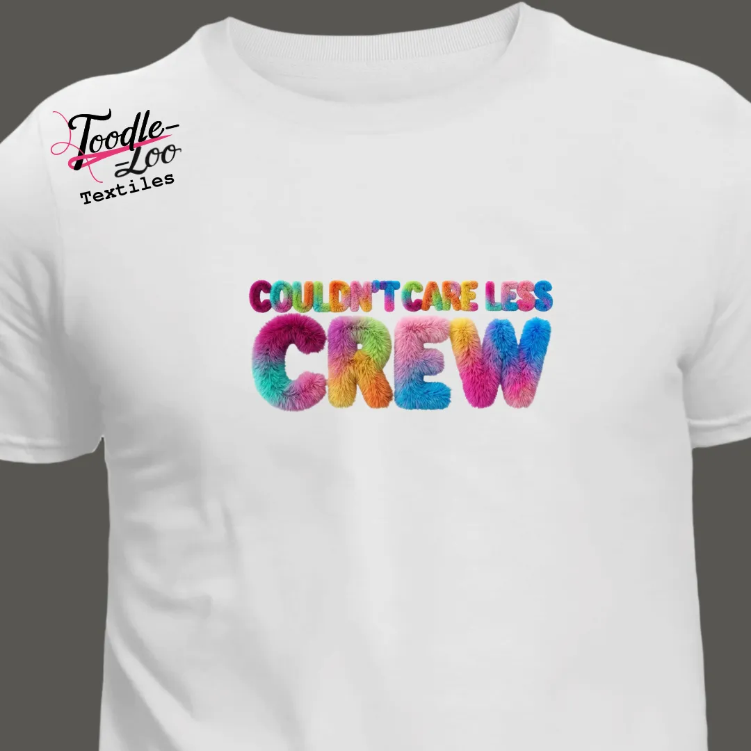 Couldn’t Care Less Crew rainbow wordmark tee — Couldn’t Care Less Crew DTF print, shown as an AI mock-up